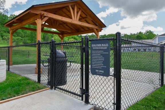 a dog park with a sign in front of a fence at The Lodge at Overland, Minnesota, 55901