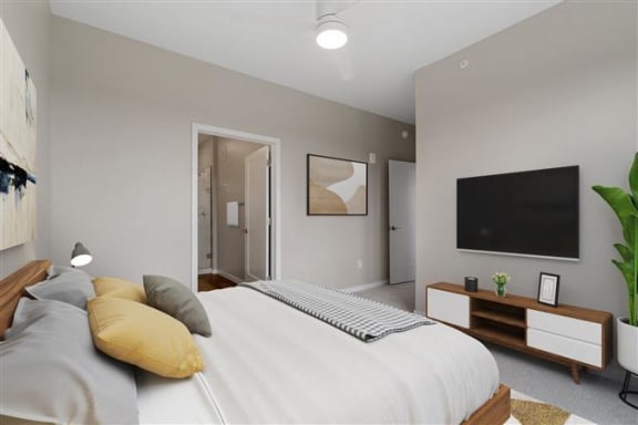 a bedroom with a large bed and a television