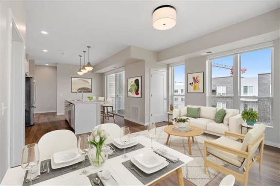 a living room and kitchen with a table and chairs