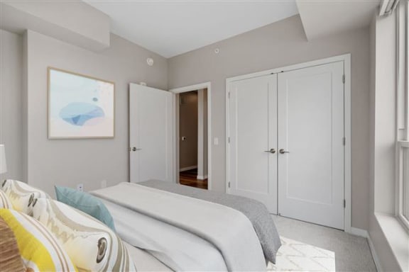 a bedroom with a bed and a door to a bathroom