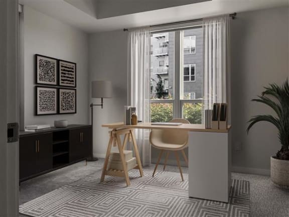 a desk and a chair in a room with a window