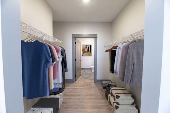 a hallway with a closet filled with clothes at The Commons at Rivertown, Grandville, 49418