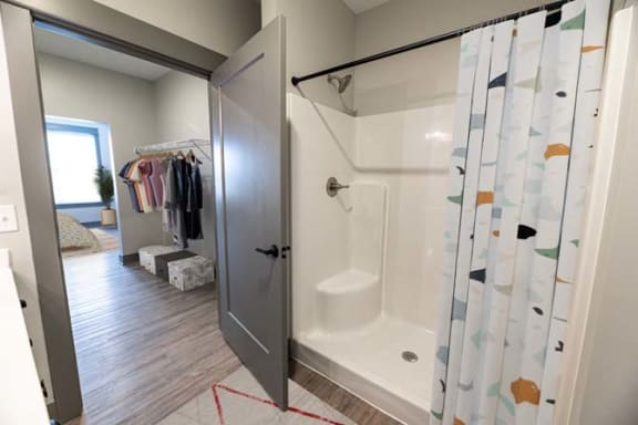 a bathroom with a shower and a closet at The Commons at Rivertown, Michigan