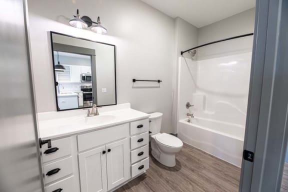 a bathroom with a sink toilet and a shower at The Commons at Rivertown, Michigan
