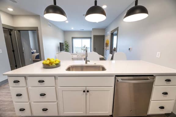 a kitchen with a sink and a counter top at The Commons at Rivertown, Grandville, 49418