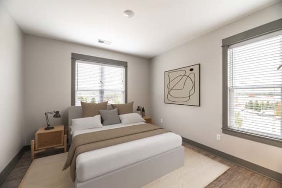 a bedroom with a bed and two windows at The Commons at Rivertown, Grandville, 49418