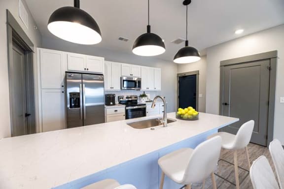 a kitchen with a counter top and a sink at The Commons at Rivertown, Michigan, 49418