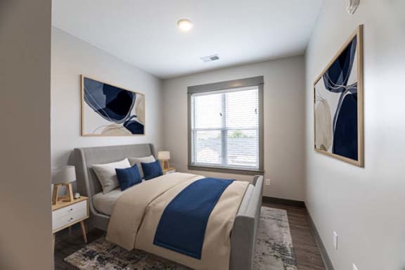 a bedroom with a large bed and a window at The Commons at Rivertown, Grandville, Michigan