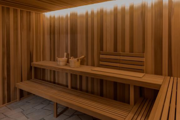 A wooden sauna with benches and towels.
