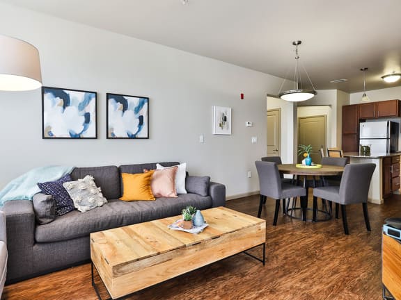 Living area with Sofa and center table at Residences at The Streets of St. Charles Apartments in  Missouri