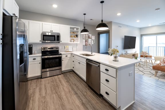 Kitchen with black appliances at The Commons at Rivertown, Grandville, 49418