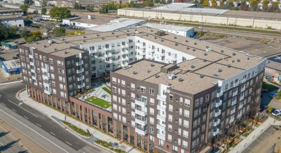 an aerial view of an apartment building on a city street