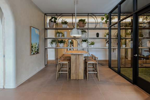 A dining room with a wooden table and chairs.