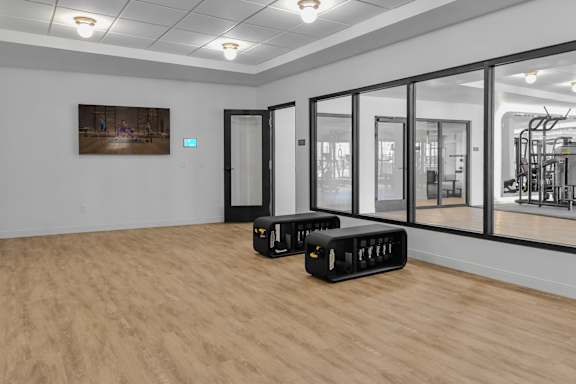 A room with a wooden floor and a painting on the wall.