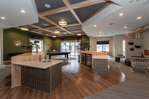 a clubhouse with a pool table and a bar in the center of the room at The Bend Arbordale, Virginia, 23188