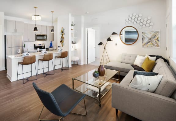 A modern living room with a grey sofa and a black chair at Parc at Princeton Junction Apartments, Princeton, NJ, 08540