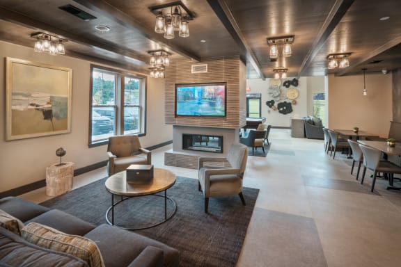 A modern living room with a large flat screen TV mounted on the wall at Parc at Princeton Junction Apartments, Princeton, 08540