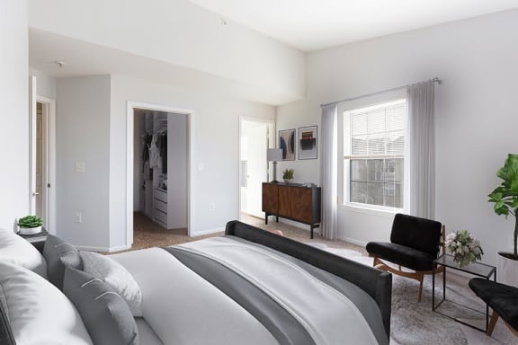 bedroom with one window and view into spacious closet