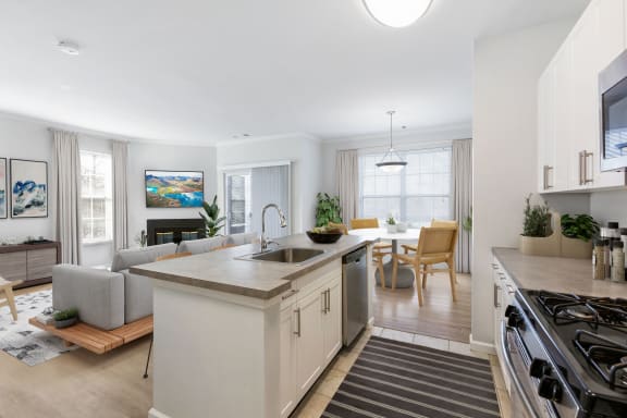 kitchen and living room space with white cabinets and an island