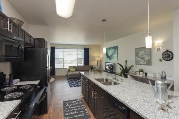 kitchen with espresso cabinets and kitchen island at Arterra Place Apartments, Aurora, Colorado