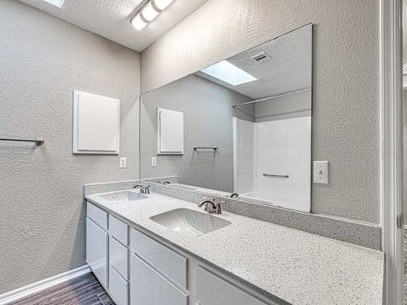 a bathroom with a sink and a mirror at Diamond Ridge Townhomes, Oklahoma