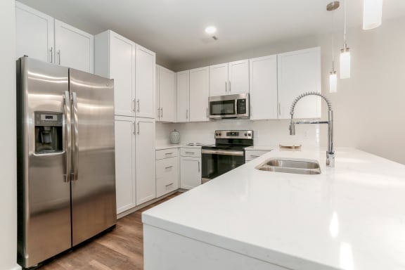 a white kitchen with stainless steel appliances and white counter tops at Annandale Apartment Homes, Murfreesboro, TN, 37128