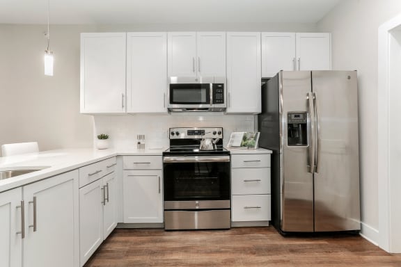 a white kitchen with stainless steel appliances and white cabinets at Annandale Apartment Homes, Murfreesboro, Tennessee