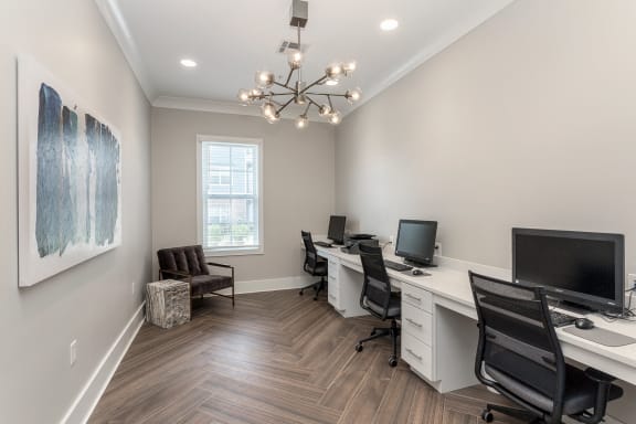 business center office with two desks and two computers and a chandelier at Annandale Apartment Homes, Murfreesboro