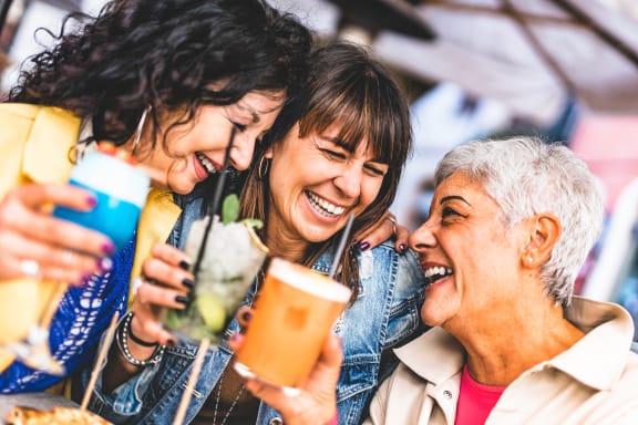 a group of people holding up drinks