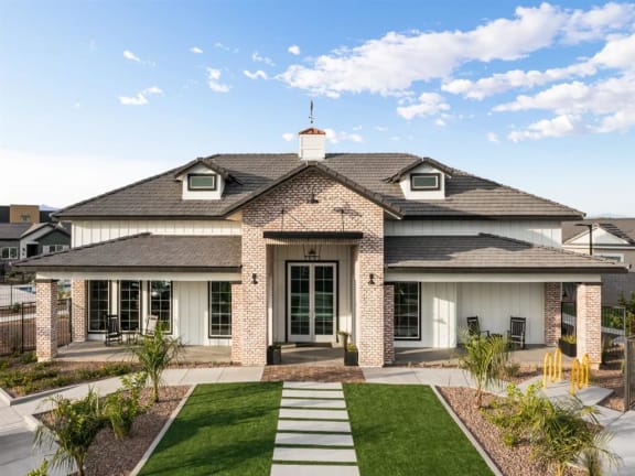 A house with a white front door and a brick chimney at Onyx at Westgate Apartments, Arizona, 85305