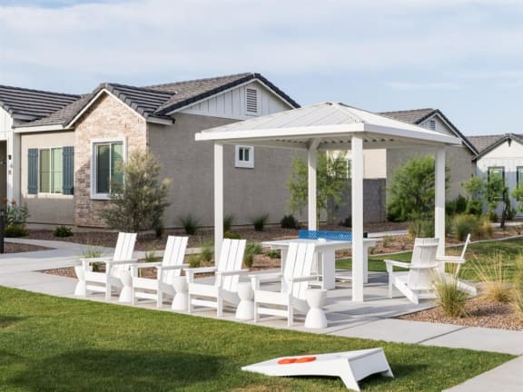 A white patio set is in front of a house at Onyx at Westgate Apartments, Glendale, AZ, 85305