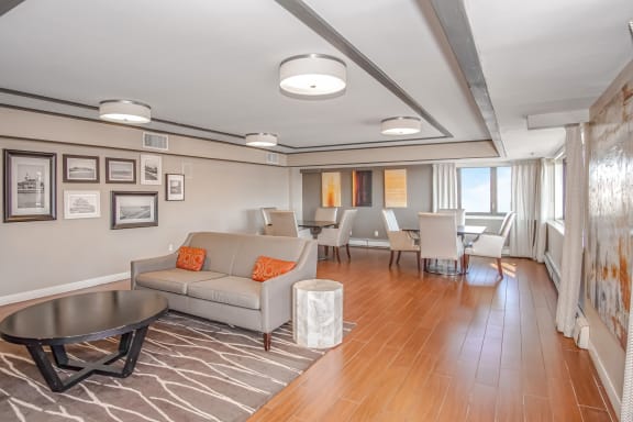 A living room with a grey couch and a coffee table at 10 West Apartments, Long Beach