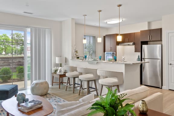 a kitchen and living room in a 555 waverly unit at Cirrus Apartments, Ashland, Massachusetts