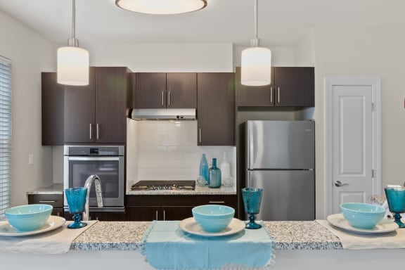 a kitchen with a large island and stainless steel appliances at Cirrus Apartments, Ashland, 01721