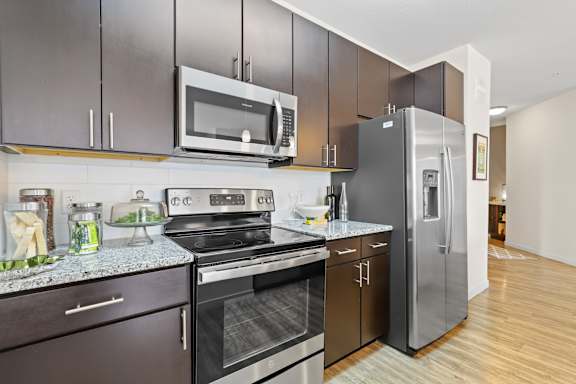 a modern kitchen with stainless steel appliances and a stainless steel refrigerator