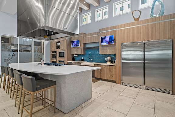 A modern kitchen with a large island and stainless steel appliances. at Centre Pointe Apartments, Florida