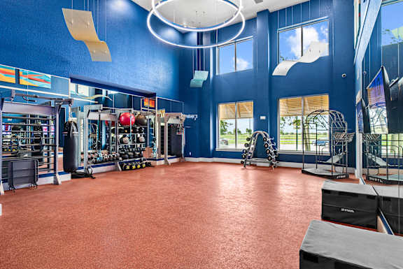 A gym with a red floor and blue walls. at Centre Pointe Apartments, Melbourne
