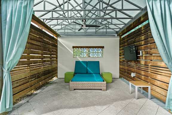 A room with a wooden wall and a blue cushion on a sofa. at Centre Pointe Apartments, Melbourne, FL