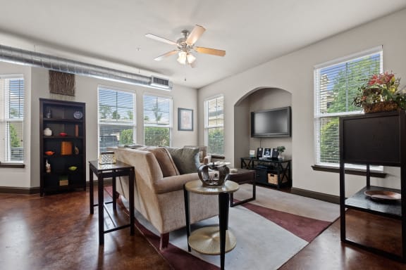 a living room with a couch and a tv at The Millennium Towne Center Apartments, Baton Rouge, Louisiana