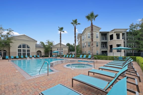 our apartments offer a large swimming pool with lounge chairs at The Millennium Towne Center Apartments, Baton Rouge, LA