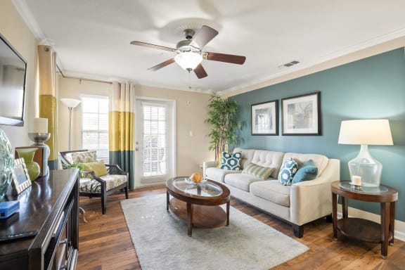 a living room with a couch and a ceiling fan  at 150 Summit, Birmingham, AL, 35243