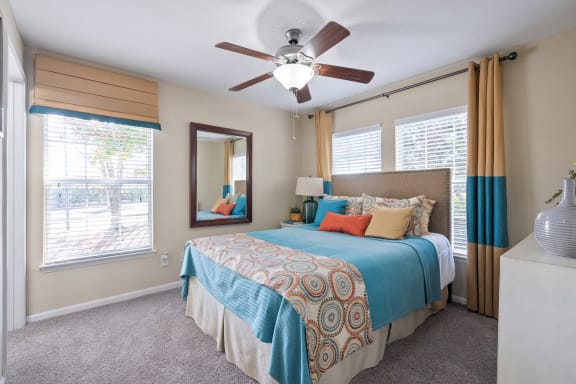 a bedroom with a large bed and a ceiling fan  at 150 Summit, Birmingham, Alabama