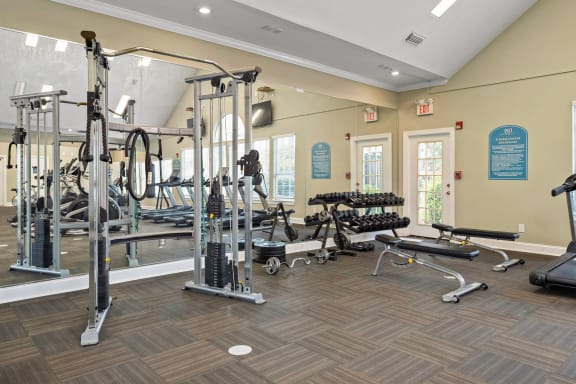 a gym with weights and cardio equipment at the at the village apartments  at 150 Summit, Alabama