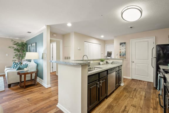 an open kitchen and living room with a large counter top  at 150 Summit, Birmingham, 35243