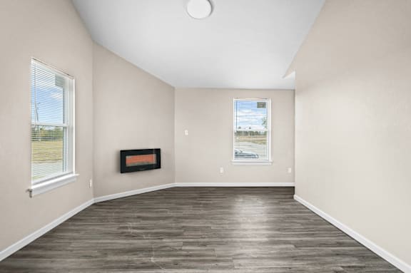 A room with a fireplace and a painting on the wall.