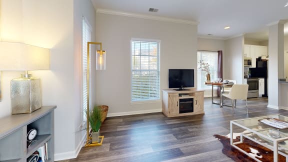 a living room with a tv and a dining room