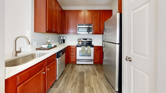 a kitchen with wooden cabinets and stainless steel appliances