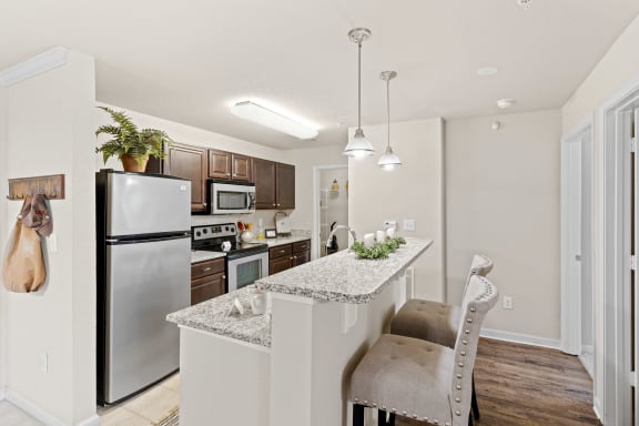 a kitchen with granite countertops and stainless steel appliances