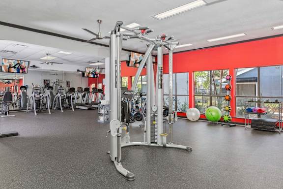 A gym with a variety of equipment including a weight machine.