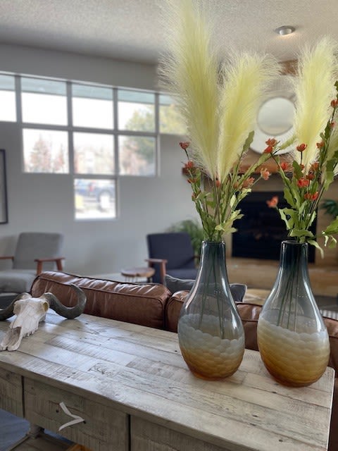 three vases on a table with flowers in them